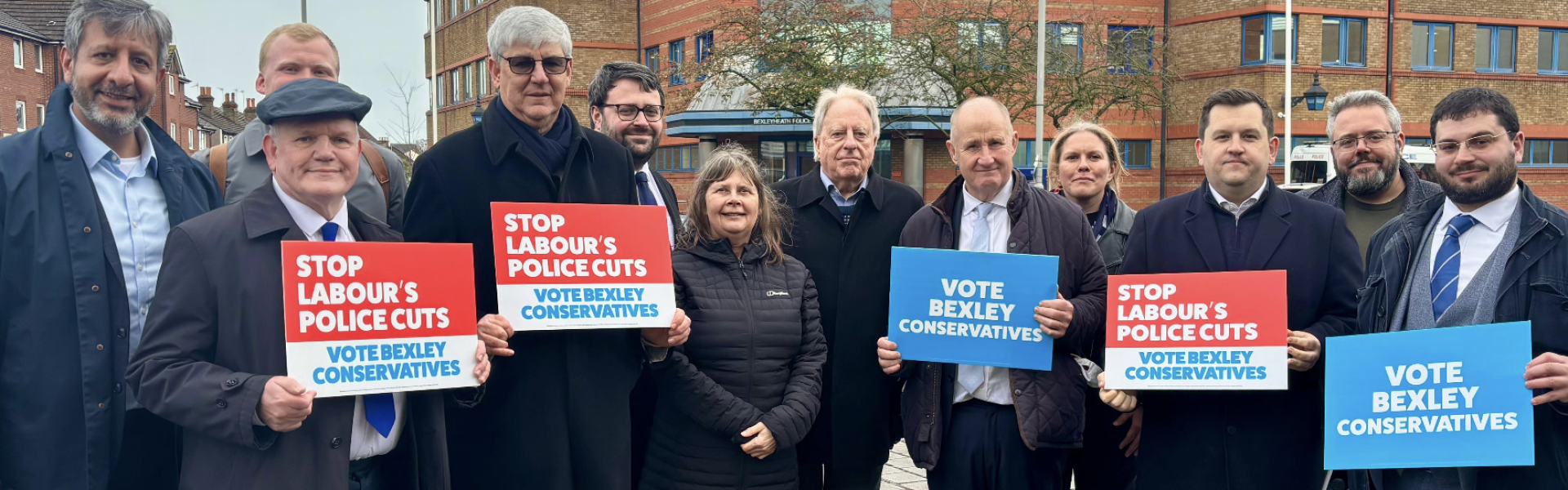 Conservative activists stand in front of Bexleyheath police station holding banners calling for the front counter to be saved