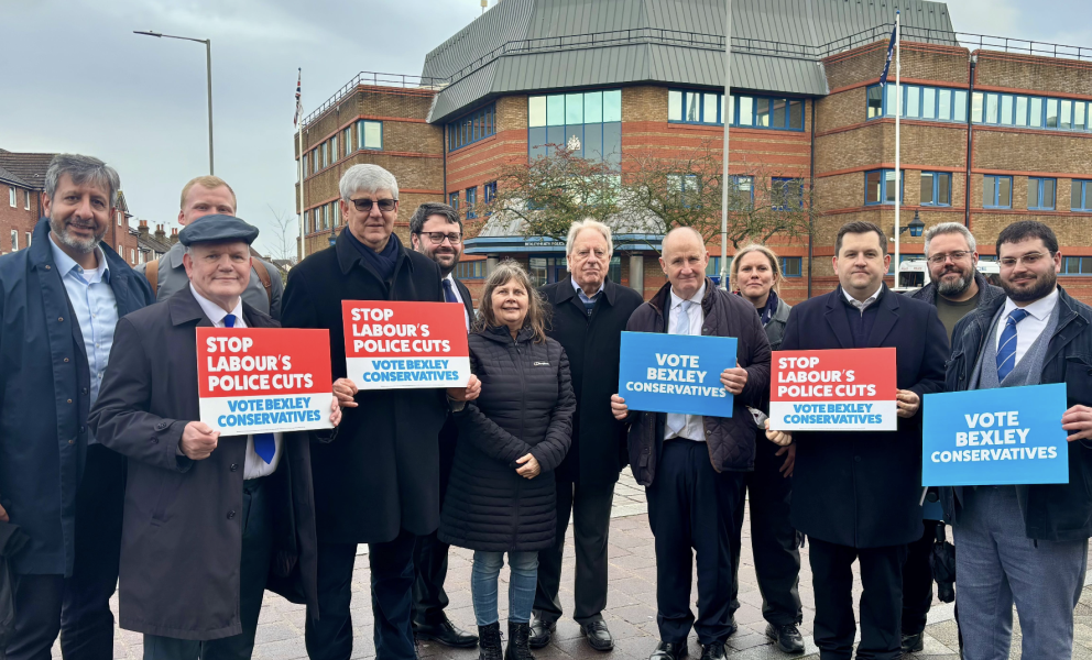 Conservative activists stand in front of Bexleyheath police station holding banners calling for the front counter to be saved
