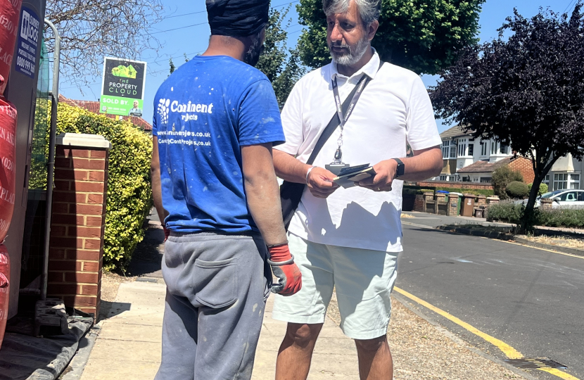 Cllr Rags Sandhu speaking to local resident 