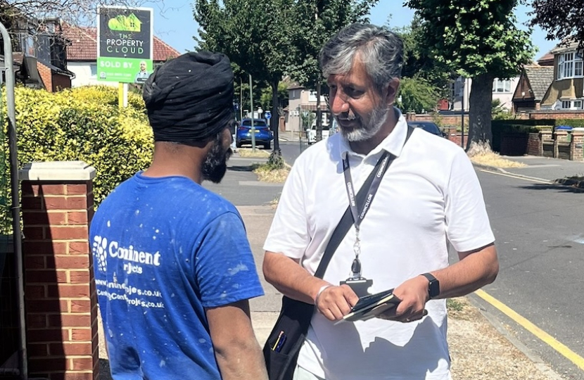 Cllr Sandu speaking to local resident 