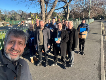 A group of conservative voters gather together smiling at the camera